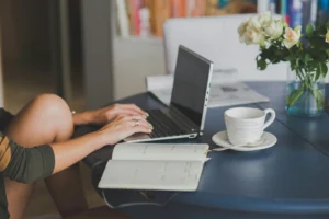Person typing on laptop at table